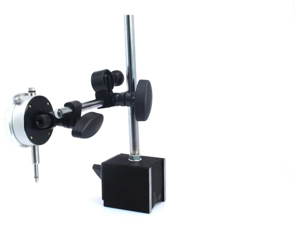 Side view of dial indicator housing, plunger and adjustable clamp attached to textured magnetic base