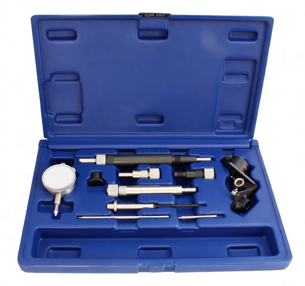 Open blue case with dial indicator, metal rods, knurled connectors and a black mounting bracket arranged in molded compartments; yellow instruction sticker in lid.