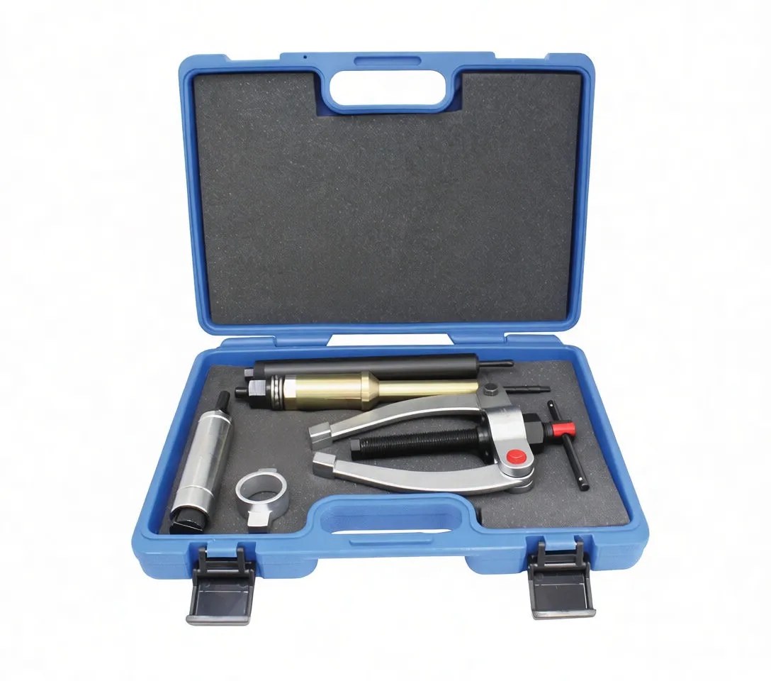 Individual metal components laid out on white background: gold and silver pullers, locating ring, two-arm puller and long black knurled installer/extractor with visible marking