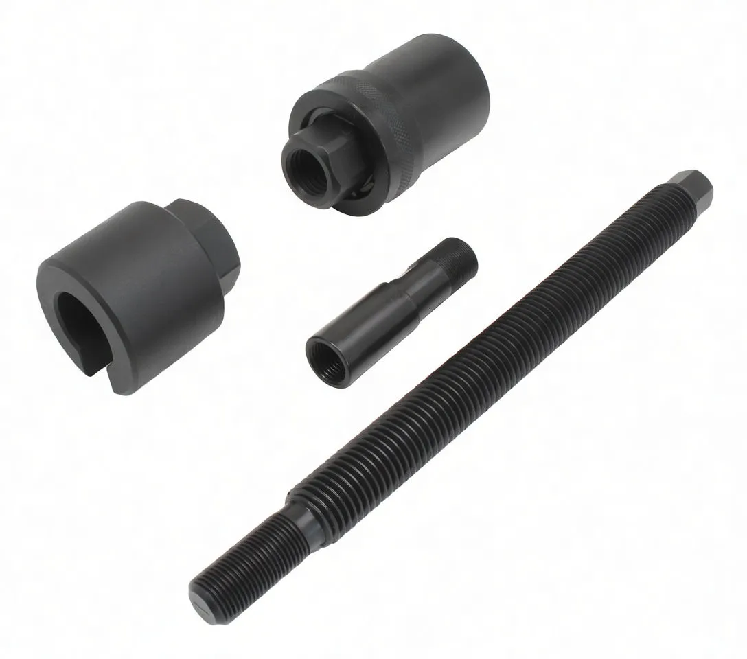 Four black metal injector extractor parts laid out: two sockets, adapter sleeve and long threaded rod, all marked ASTA.