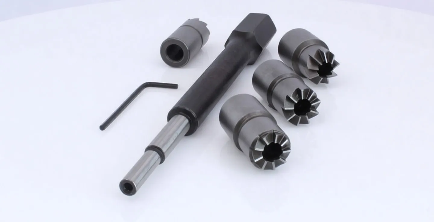 Angled arrangement of driver, multiple star-tooth cutter heads and Allen key for diesel injector seat cleaning