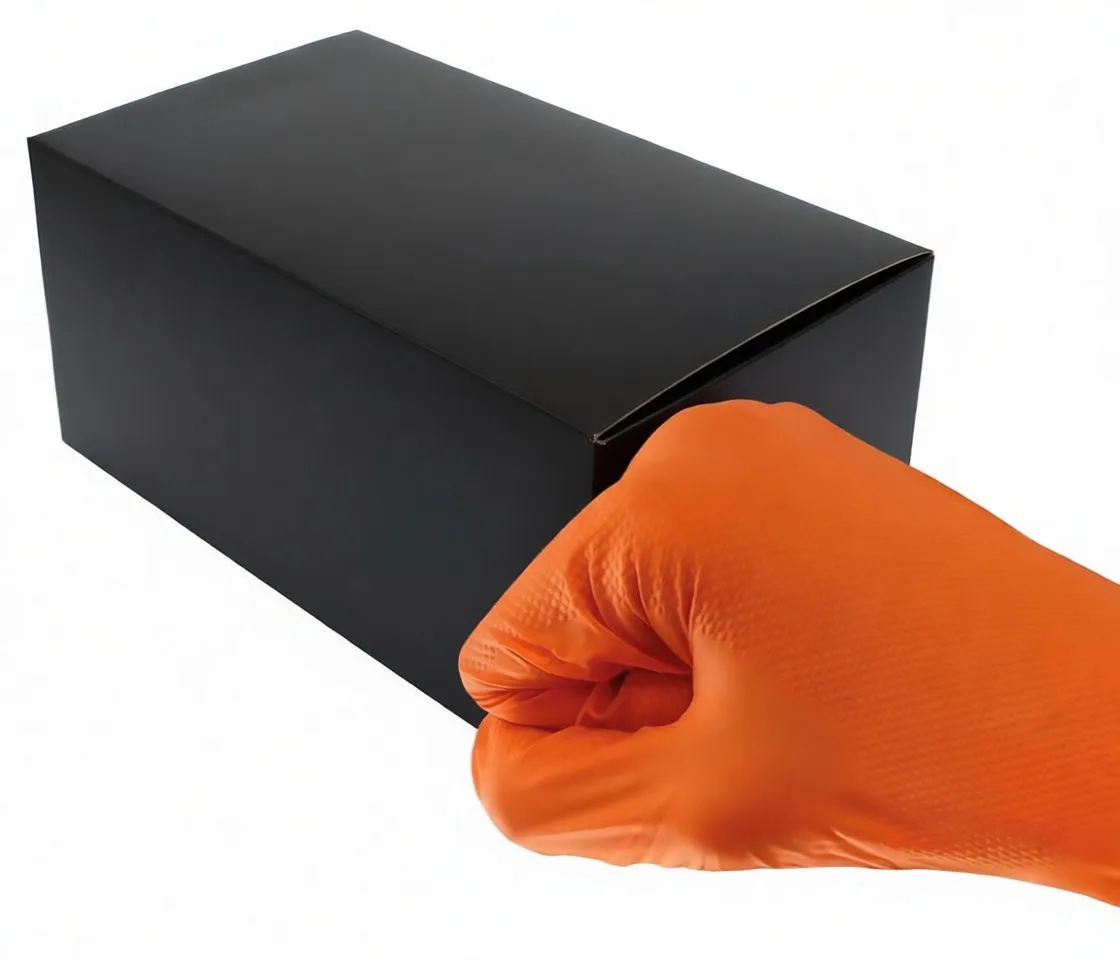 Orange nitrile glove with textured fingertips held in front of product box