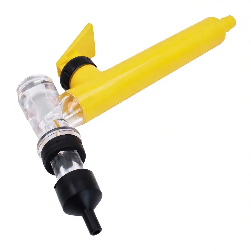 Angled close-up of filler showing clear chamber, black nozzle tip, O-rings and yellow handle.