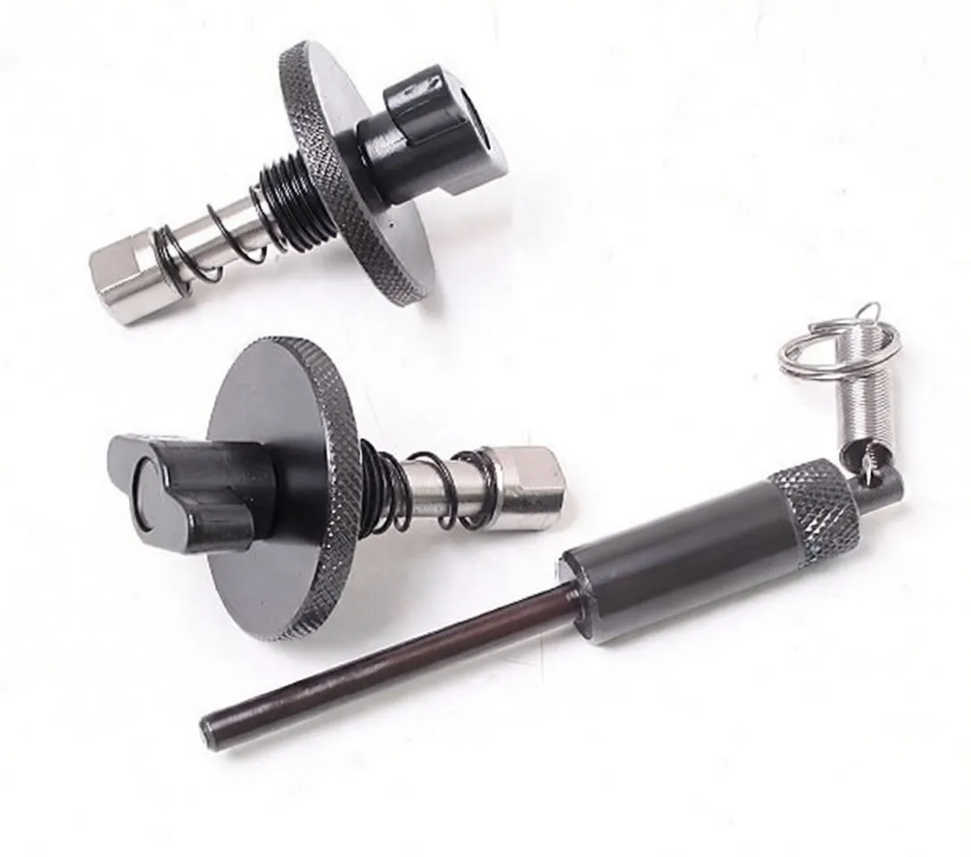 Close-up of two black flange locking bolts with springs and a long knurled alignment pin marked A-9018, plus a coil spring