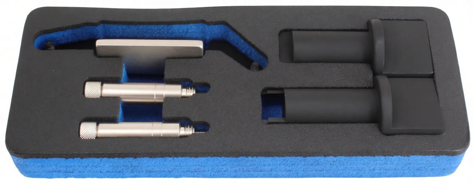 Top view of foam insert holding timing adaptor: two silver pins, a metal bracket and two black adapter sleeves labeled IN. and EX.