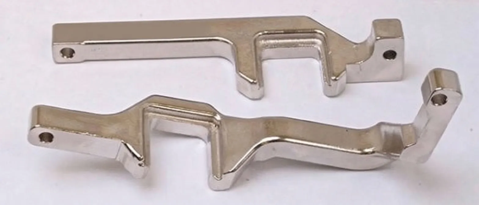 Two chrome-plated timing locking arms laid flat, showing bends, mounting holes and faint stamped markings