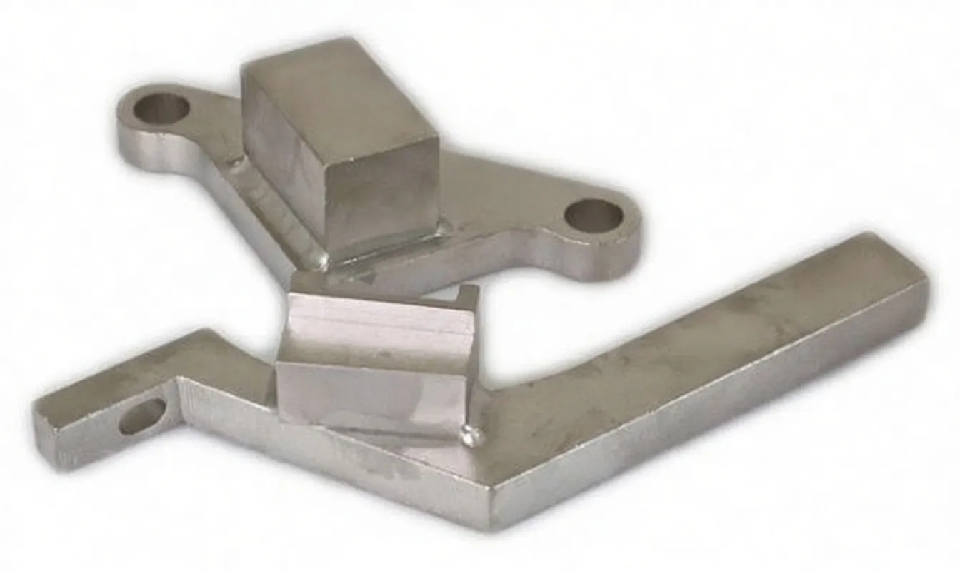 Two machined aluminium timing brackets — a three-lobed mount with a central block and an angled arm with a locating pin and logo