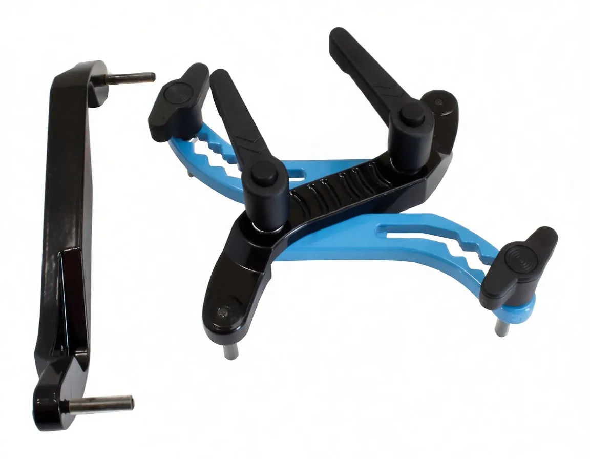 Close-up of black three-legged timing clamp with blue serrated guide and separate black lever, showing metal locating pins and 'ASTA' marking.