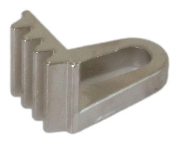 Close-up of a small wedge-shaped aluminium locator with an oval slot and ribbed tooth-like edge