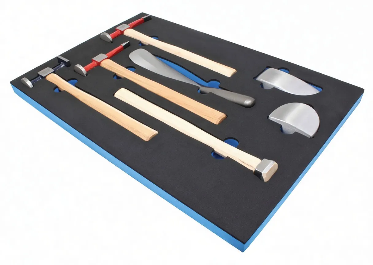 Angled view of a black-and-blue foam tool module with hammers, a metal dolly and half-moon dollies, ASTA logo visible