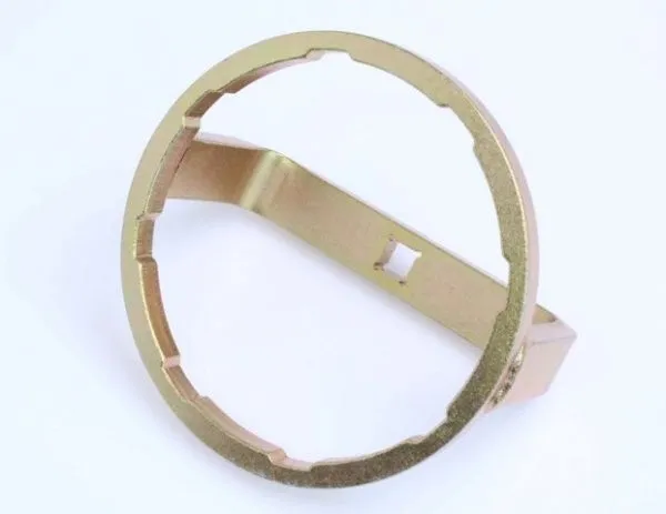 Top view of gold plated circular fuel filter wrench showing inner notches around the ring and the central bridge with a square drive hole.