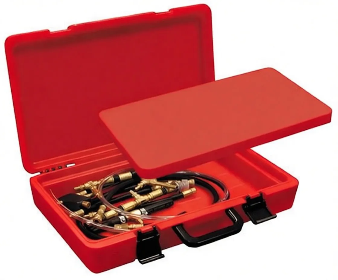 Open red toolbox-style case showing fuel injection test kit: two gauges, many brass adapters, and a lower compartment with hoses and connectors; label on lid reads FUEL INJECTION TEST SET.