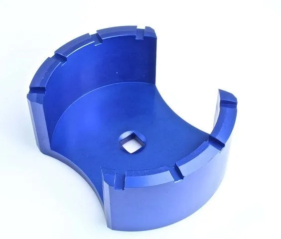 Inside view of blue alloy fuel tank lid tool showing inner chamber, multiple notches and square drive socket