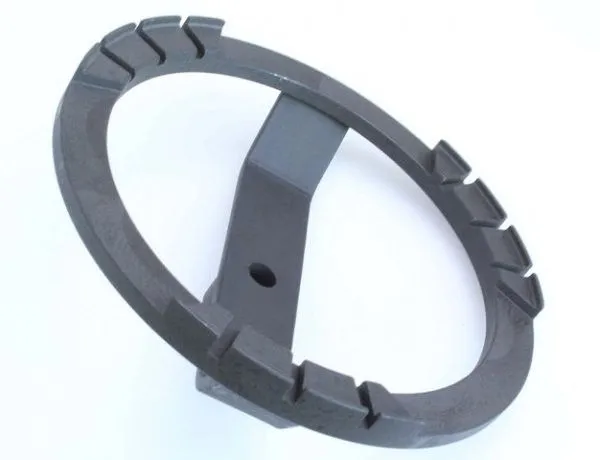 Angled view of fuel tank lid tool showing inner notches on ring and central arm with hole