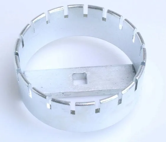 Overhead view of a silver plated circular locking-ring tool with internal notches and a central bar containing a square drive hole.