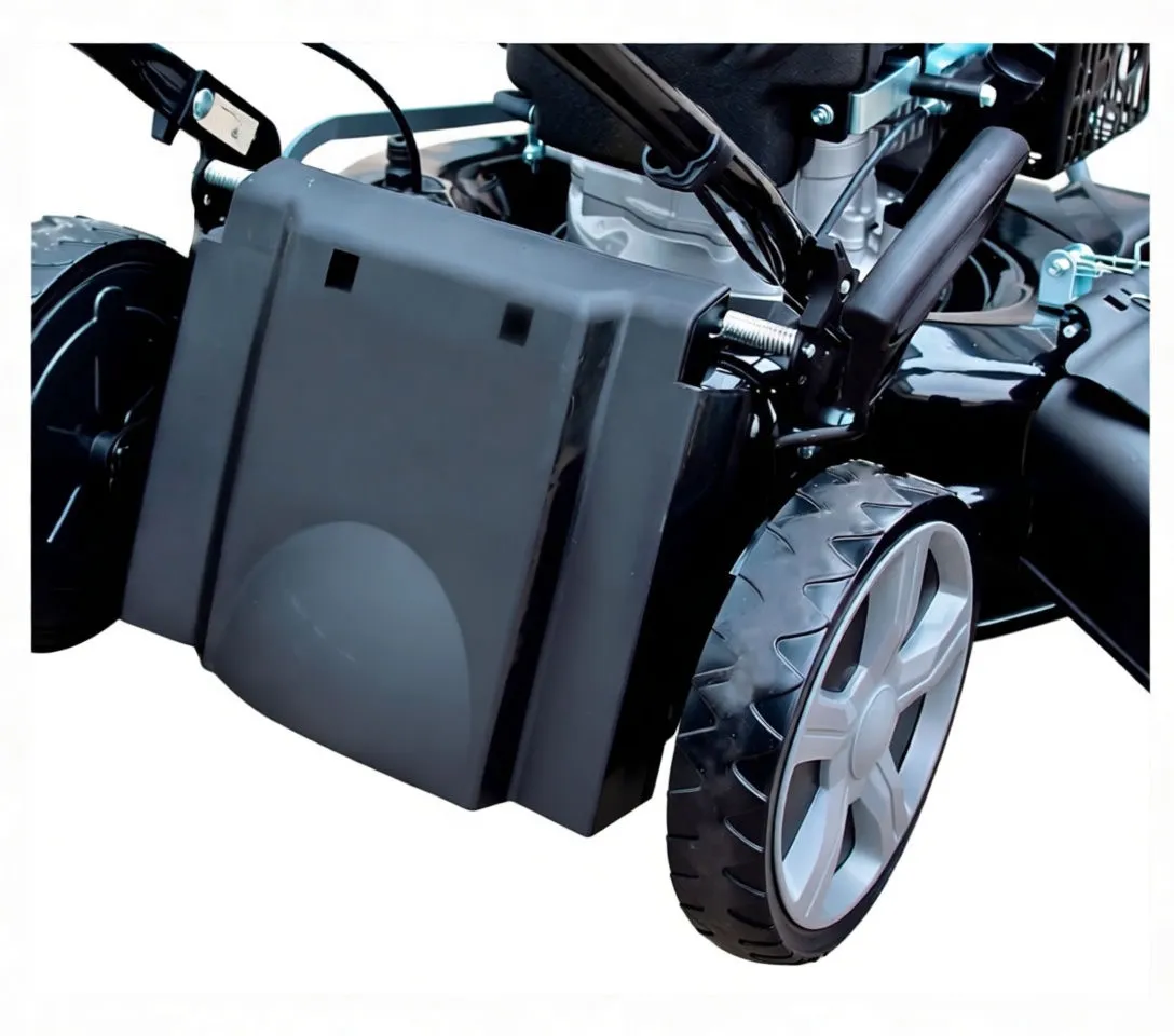 Top-down view of mower engine cover with 'saTra' sticker and fuel cap, front of cutting deck