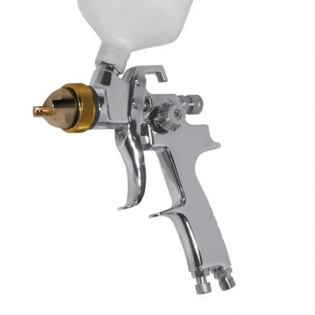 Close-up of chrome paint gun showing gold air cap, nozzle, adjustment knobs and embossed marking on grip