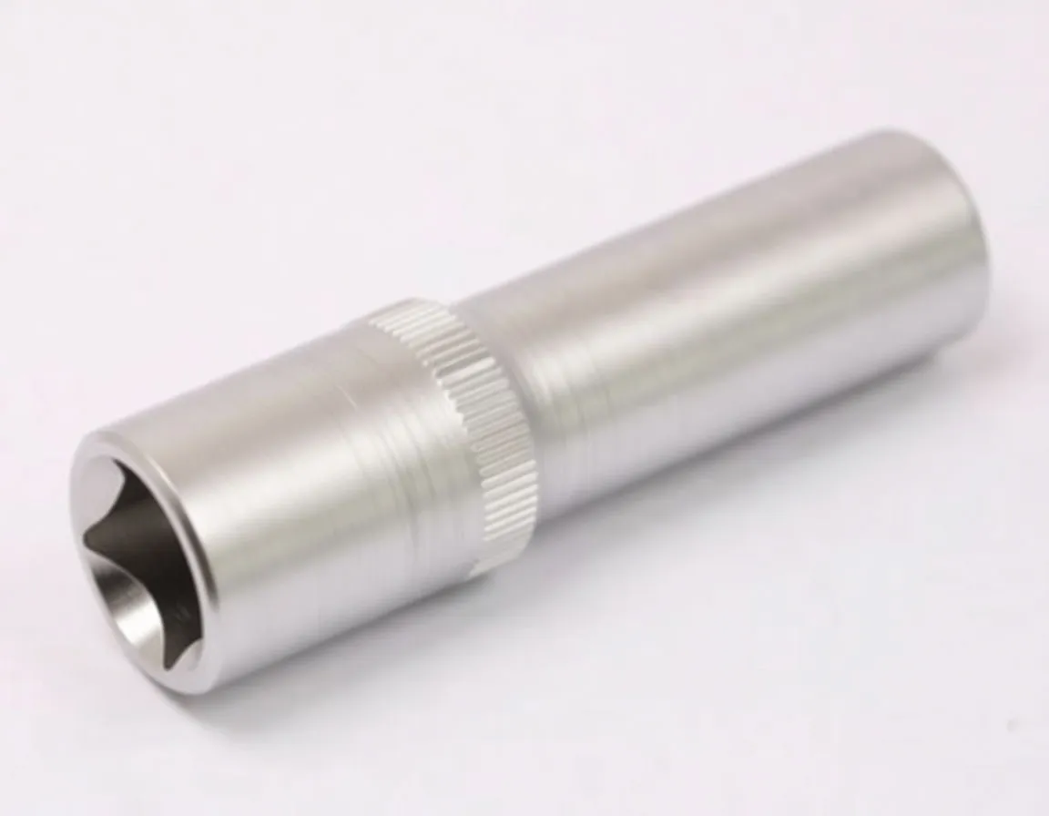 Angled view of a chrome short E-type socket showing star recess, knurled band and stamped marking