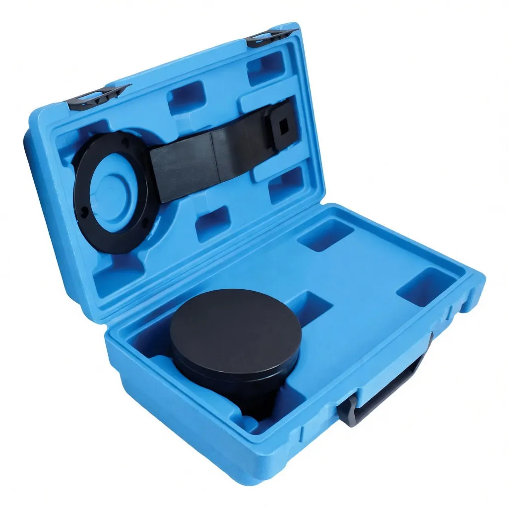Side-angled view of blue tool case with black circular puller cup in base and ring-and-arm holding wrench in lid, showing molded storage compartments.