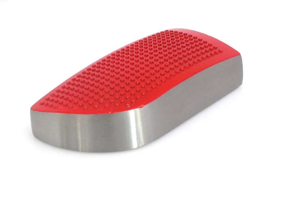 Angled image of a brushed metal block with a convex red studded rubber top, rounded end and satin finish sides.
