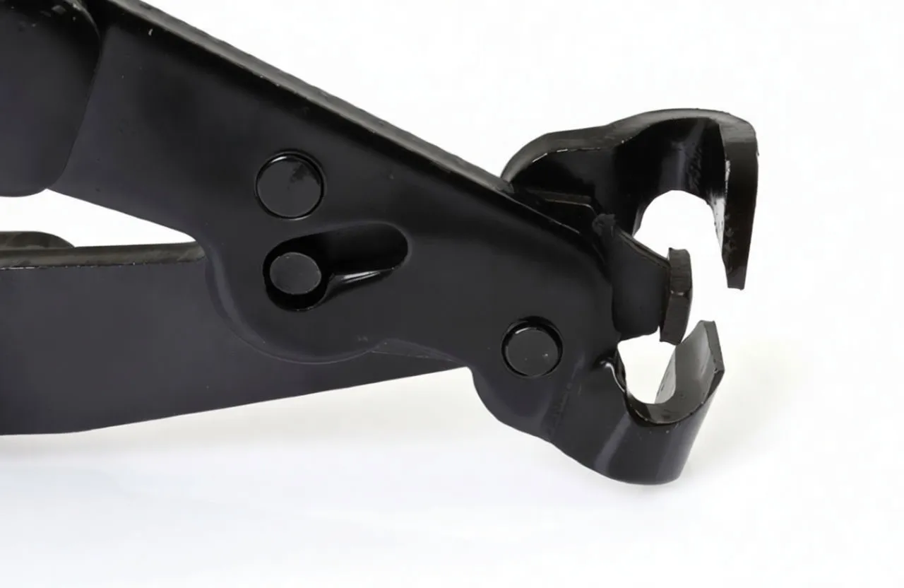 Macro view of pliers jaw notch and pivot screw, showing U-shaped clamp seat and worn metal surfaces