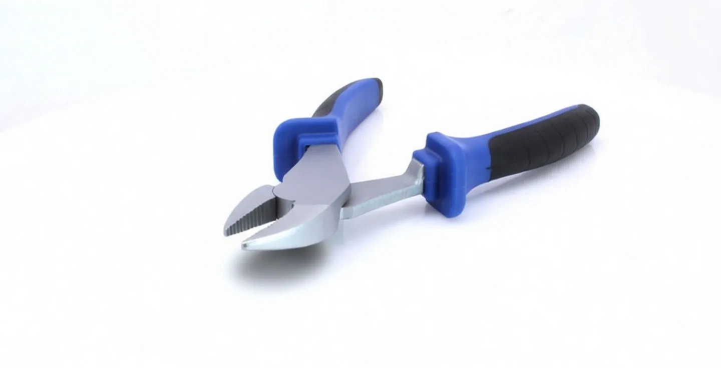 Low-angle close-up of diagonal pliers with blades toward camera, showing sharp cutting edges, stamped text on the metal head, and blue-and-black ergonomic handles.