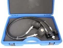 Top-down small view of blue case with two hydraulic pistons, hoses and a black mounting block