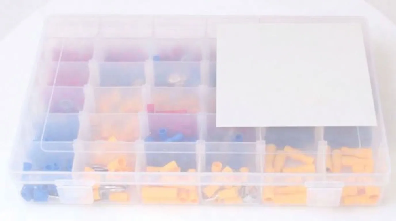Closed clear organizer box with ASTA label showing product code and '480 pcs', containing red, blue and yellow insulated crimp connectors