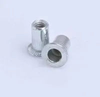 Two silver M10 rivet nuts showing threaded bore, knurled shank and flanged head