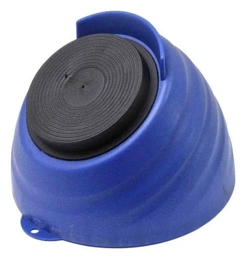Underside of blue tool tray showing black circular magnetic pad with concentric rings and a small rim notch