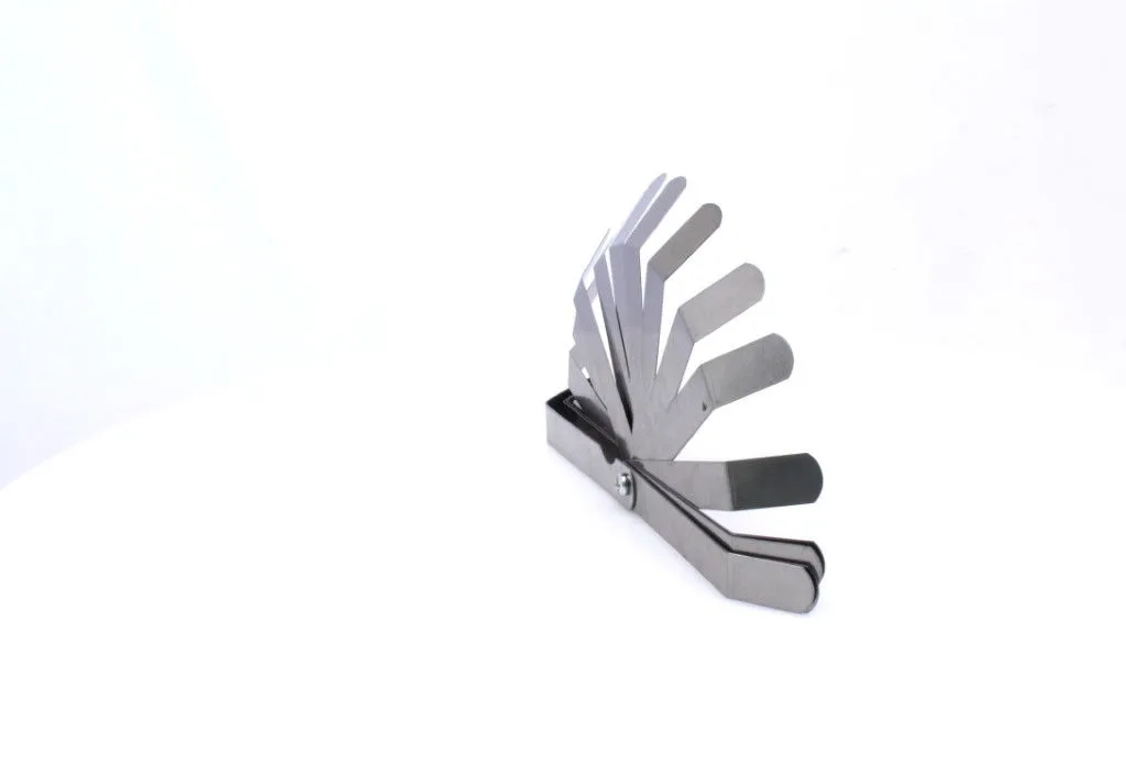 Angled profile of an offset feeler gauge with blades fanned up, showing offset tips, pivot rivet and stacked stainless steel leaves.