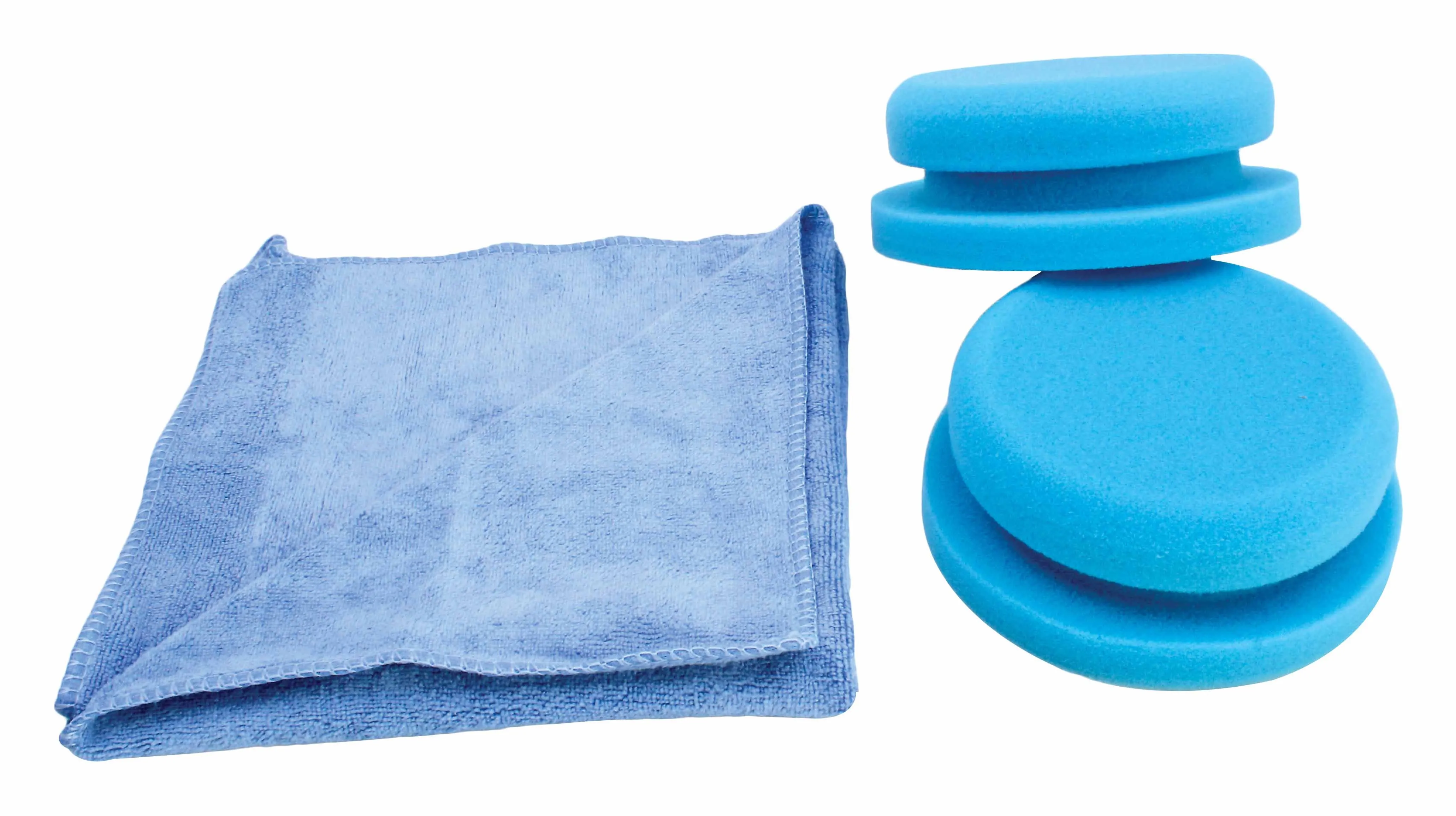 Folded light-blue microfiber towel beside two stacked blue round foam polishing pads on white background.