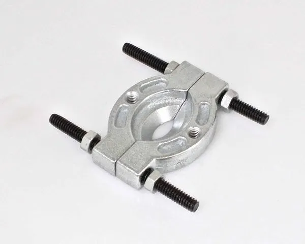 Close-up of silver two-piece bearing separator with four black threaded bolts