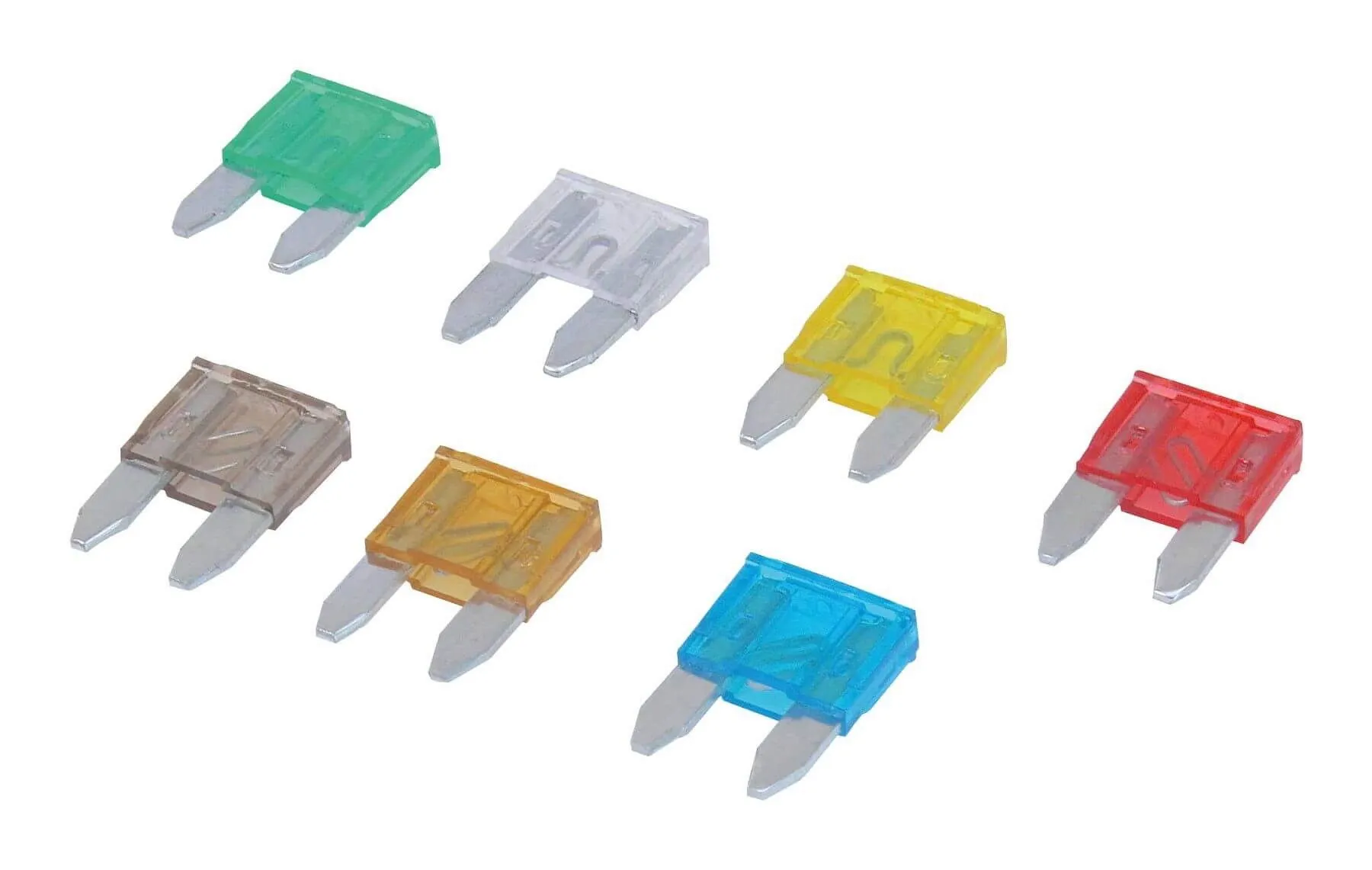 Close-up of seven mini blade fuses in different translucent colors laid out on white background, showing metal blades and internal fuse links.