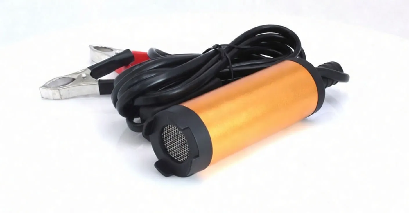 Side view of orange mini diesel pump with coiled cable and battery clips, text on body