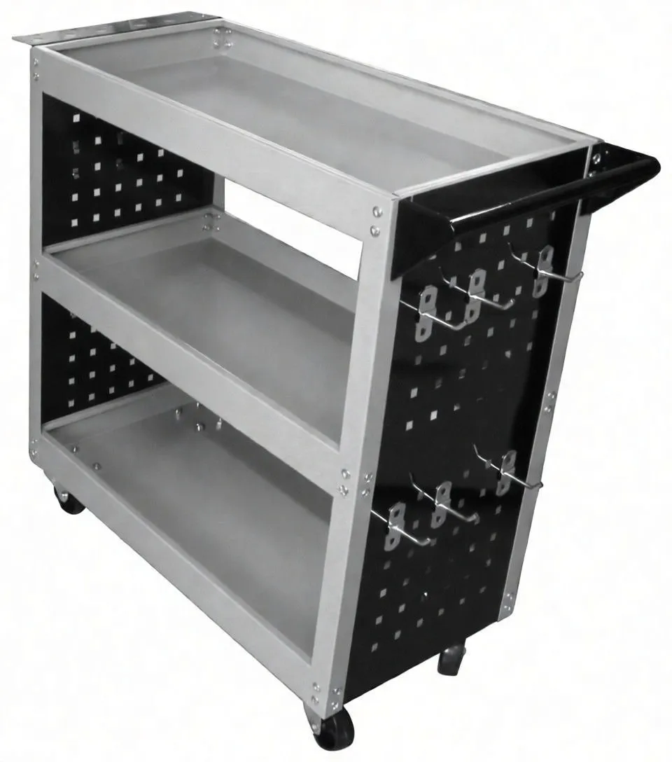 Side-angled image of VISTA three-shelf tool cabinet showing pegboard with hooks, black handle, raised-edge trays and casters