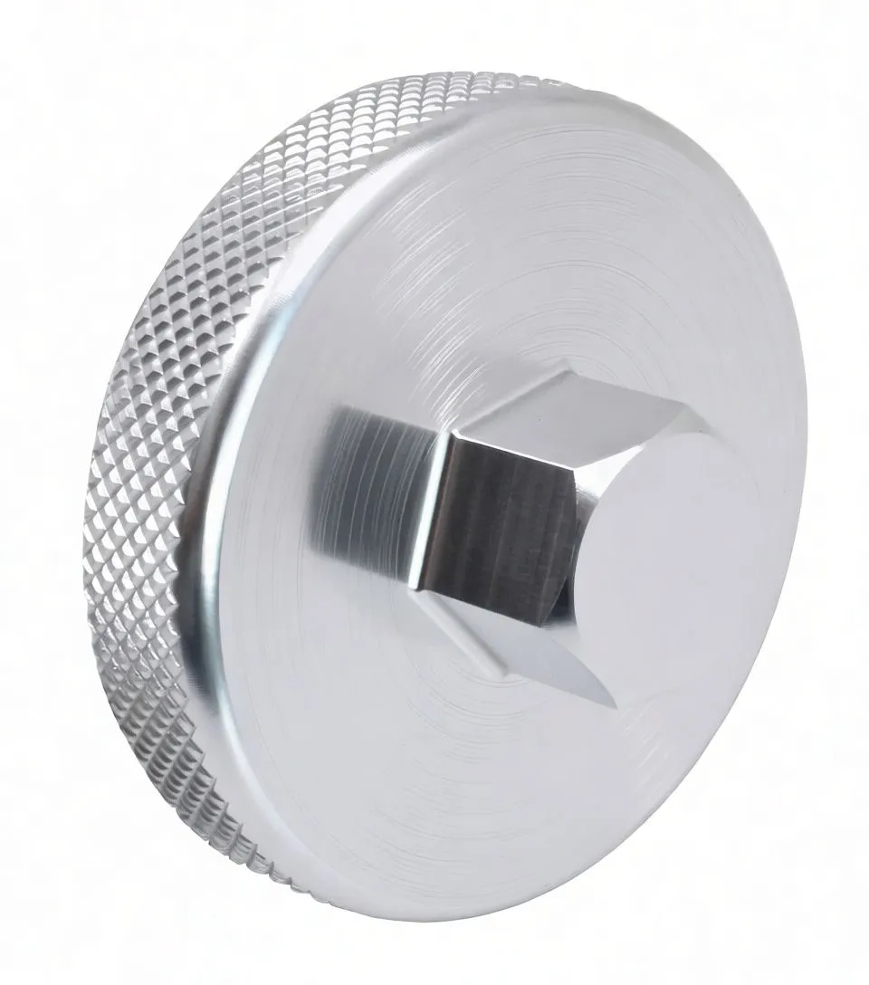 Angled side image of silver machined fork cap removal tool with knurled rim and central hex boss, ASTA logo visible.