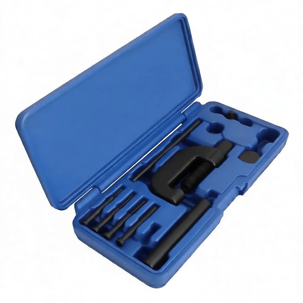 Angled shot of blue tool case showing C-frame press, knurled handle, multiple punch pins and dies
