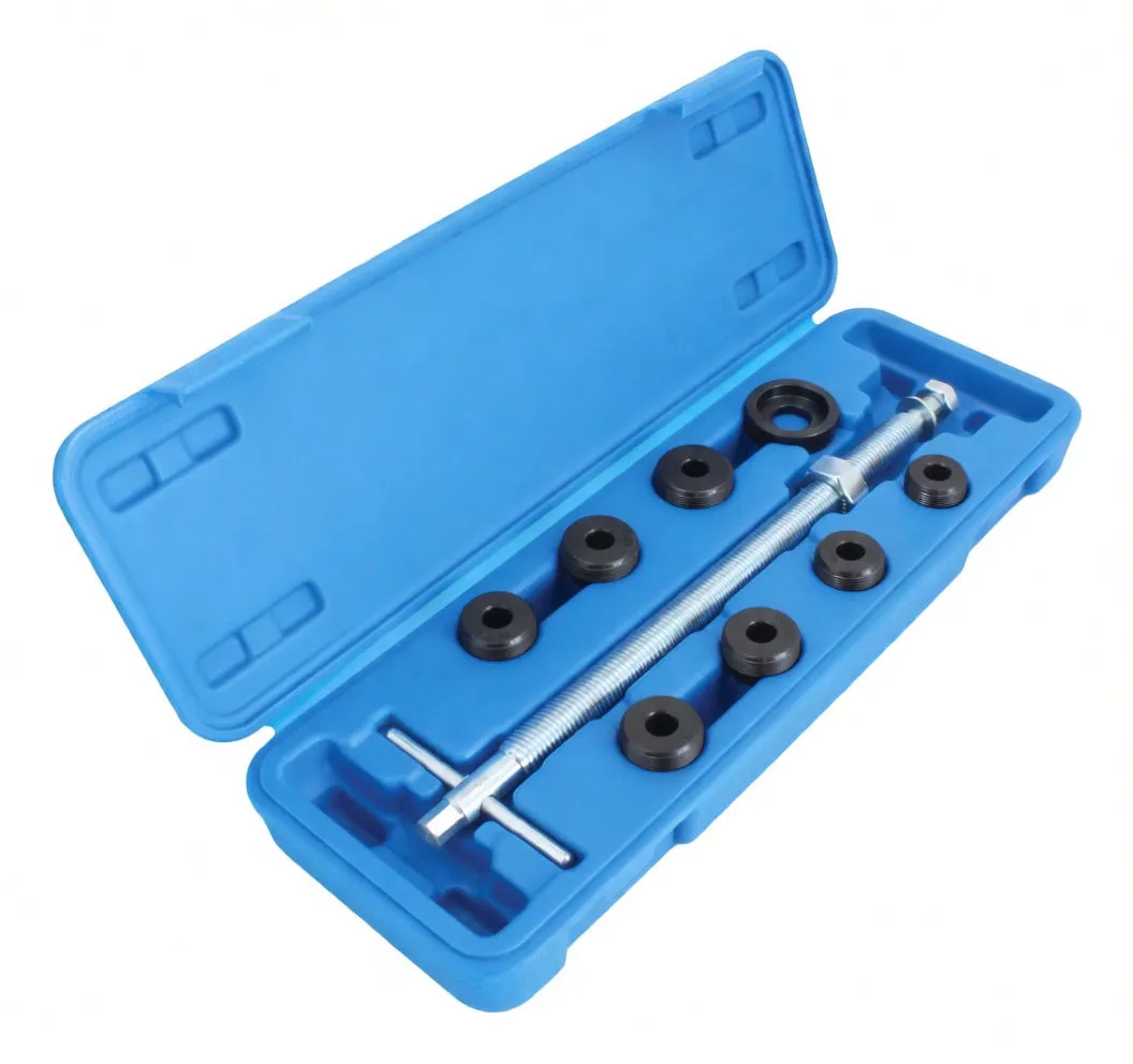 Angled view of a fork tube puller kit in a blue molded case showing the threaded rod, nuts and several black adapter collars
