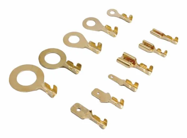 Close-up of various gold non‑insulated ring terminals and male/female crimp connector pins