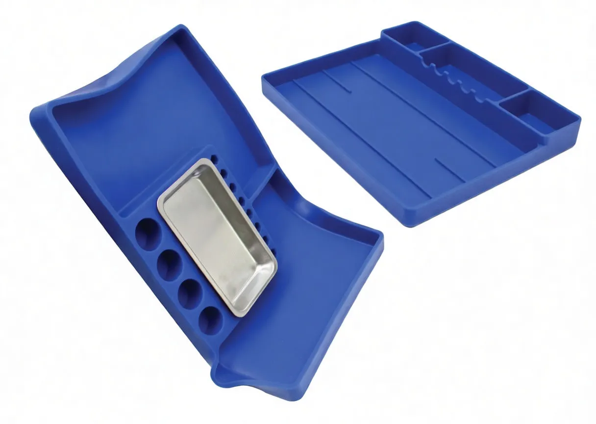 One blue tool tray bent to show flexibility with a stainless steel tray and bit holes; another tray flat in background.