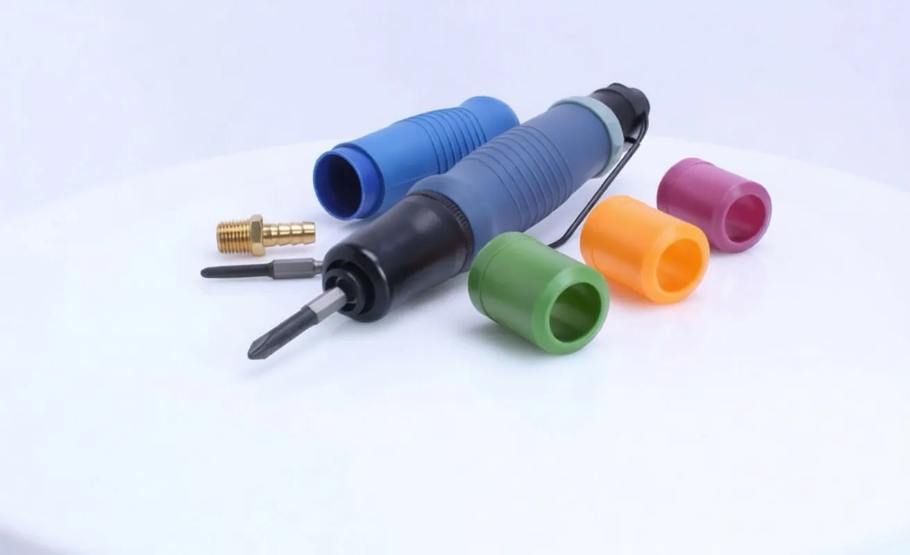 Rear view of pneumatic screwdriver with blue sleeve removed, brass air inlet, foam exhaust and colored caps