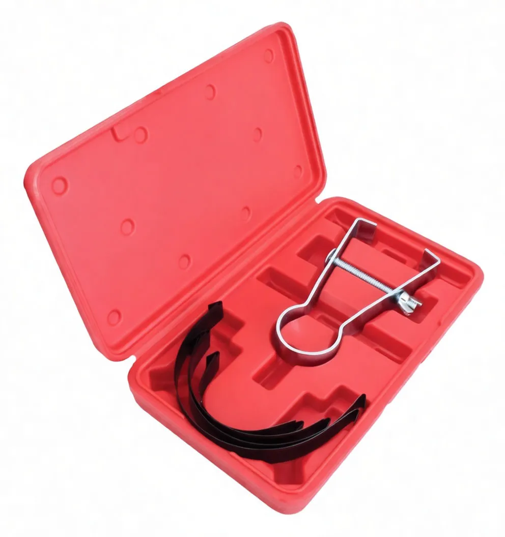 Angled view of open red case showing piston ring compressor clamp with threaded screw and nested black adapters