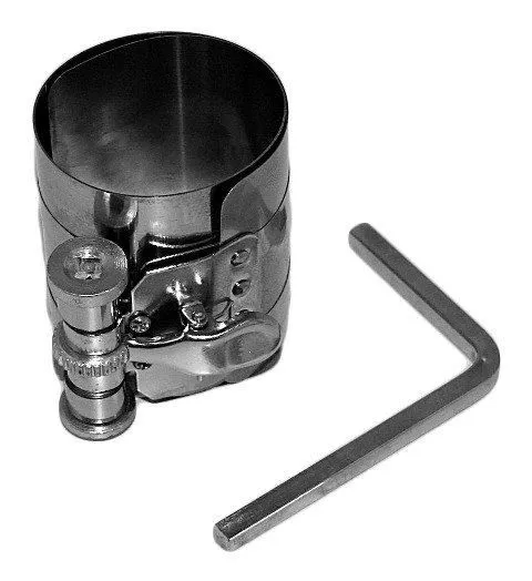 Top view of piston ring compressor band and chrome cam clamp with hex key beside it