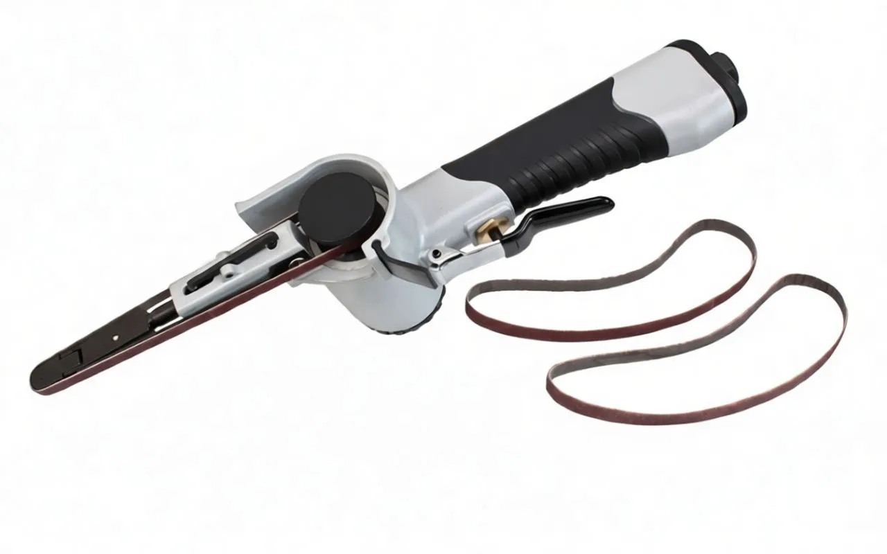 Angled top-right view of pistol-grip air belt sander with trigger, spare belts, and hex keys