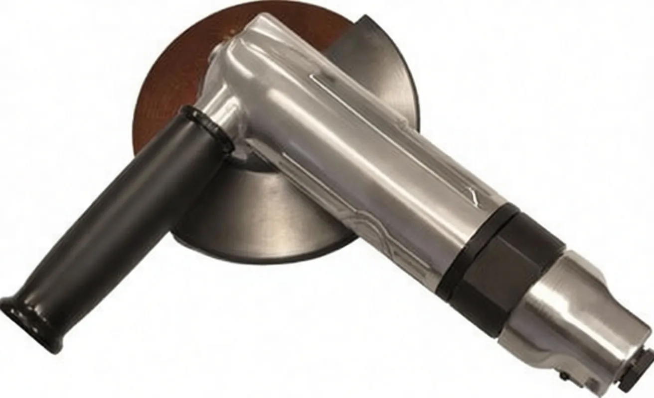 Close-up of grinder head showing threaded spindle, black guard, side handle and lever mechanism