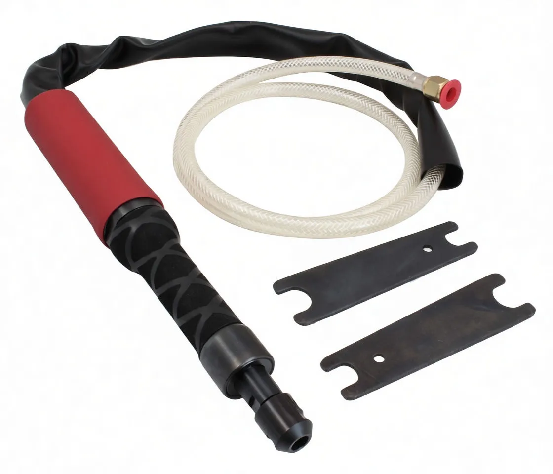 Close view of pneumatic grinder collet, textured grip, coiled braided hose and accessory wrenches