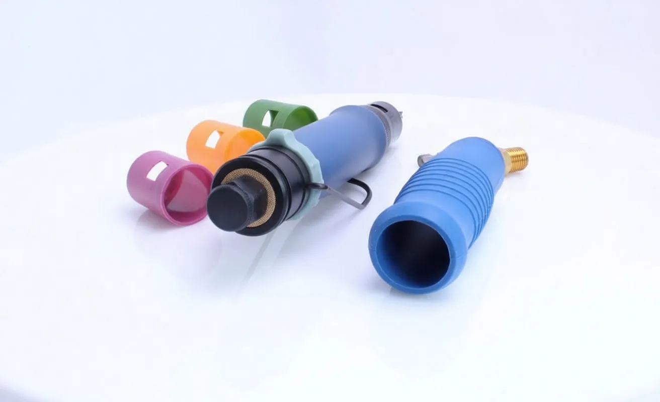 Rear view of pneumatic screwdriver with detached blue sleeve, brass hose connector and colored caps on white background.