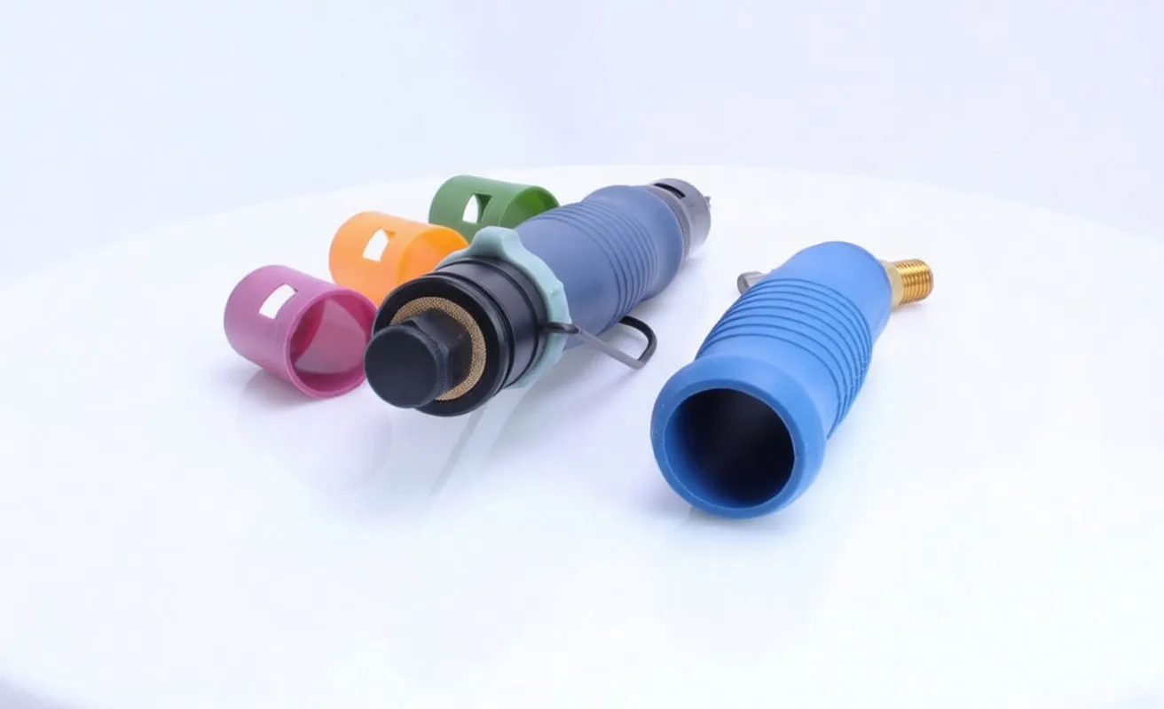 Pneumatic screwdriver partially disassembled showing rear muffler, blue sleeve removed, brass inlet and colored caps