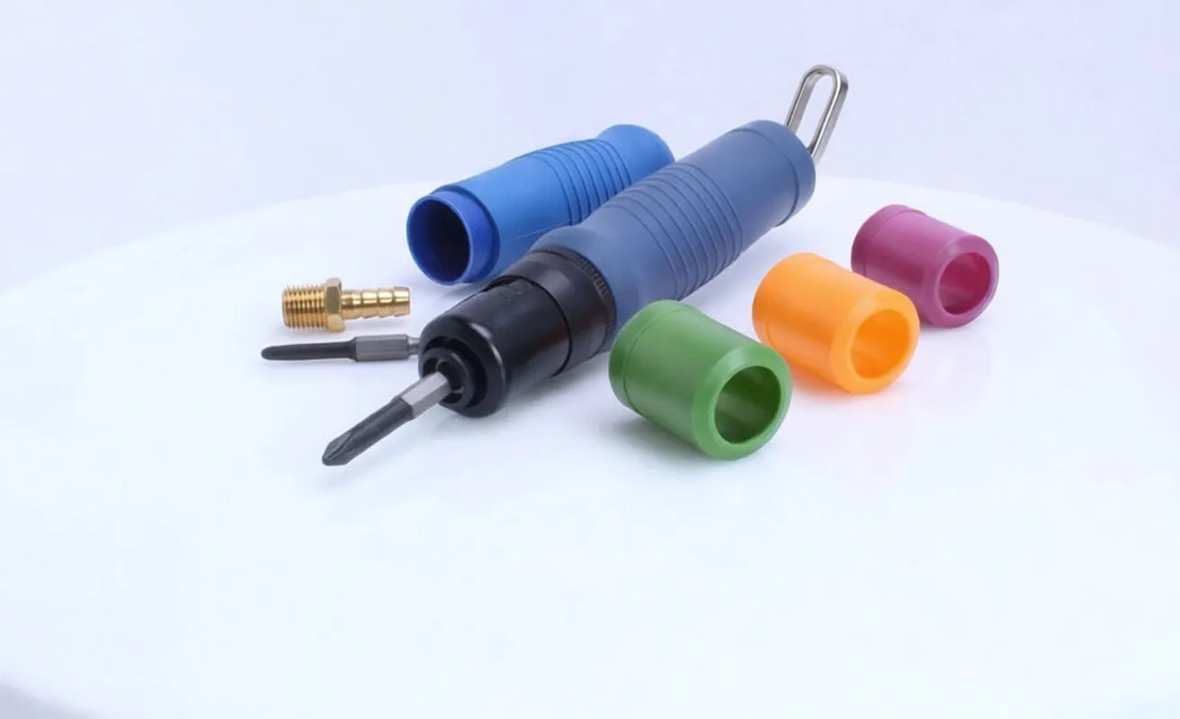 Pneumatic screwdriver with colored depth collars, spare bit and brass air fitting on white surface